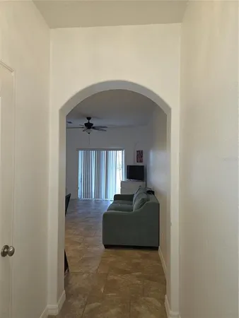 a hallway with a couch and a window