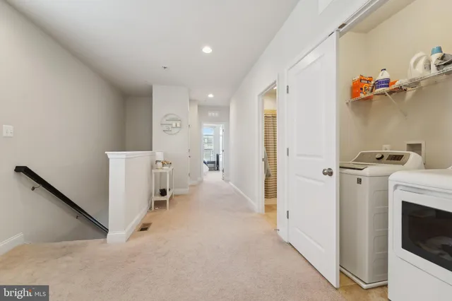 a view of a hallway with workspace and a fireplace
