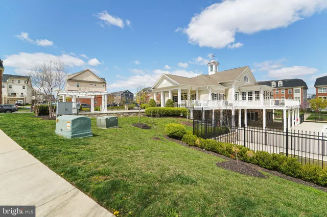 a front view of a house with a yard table and chairs