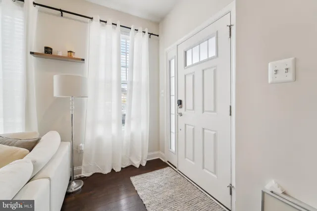a view of a hallway with wooden floor and closet area