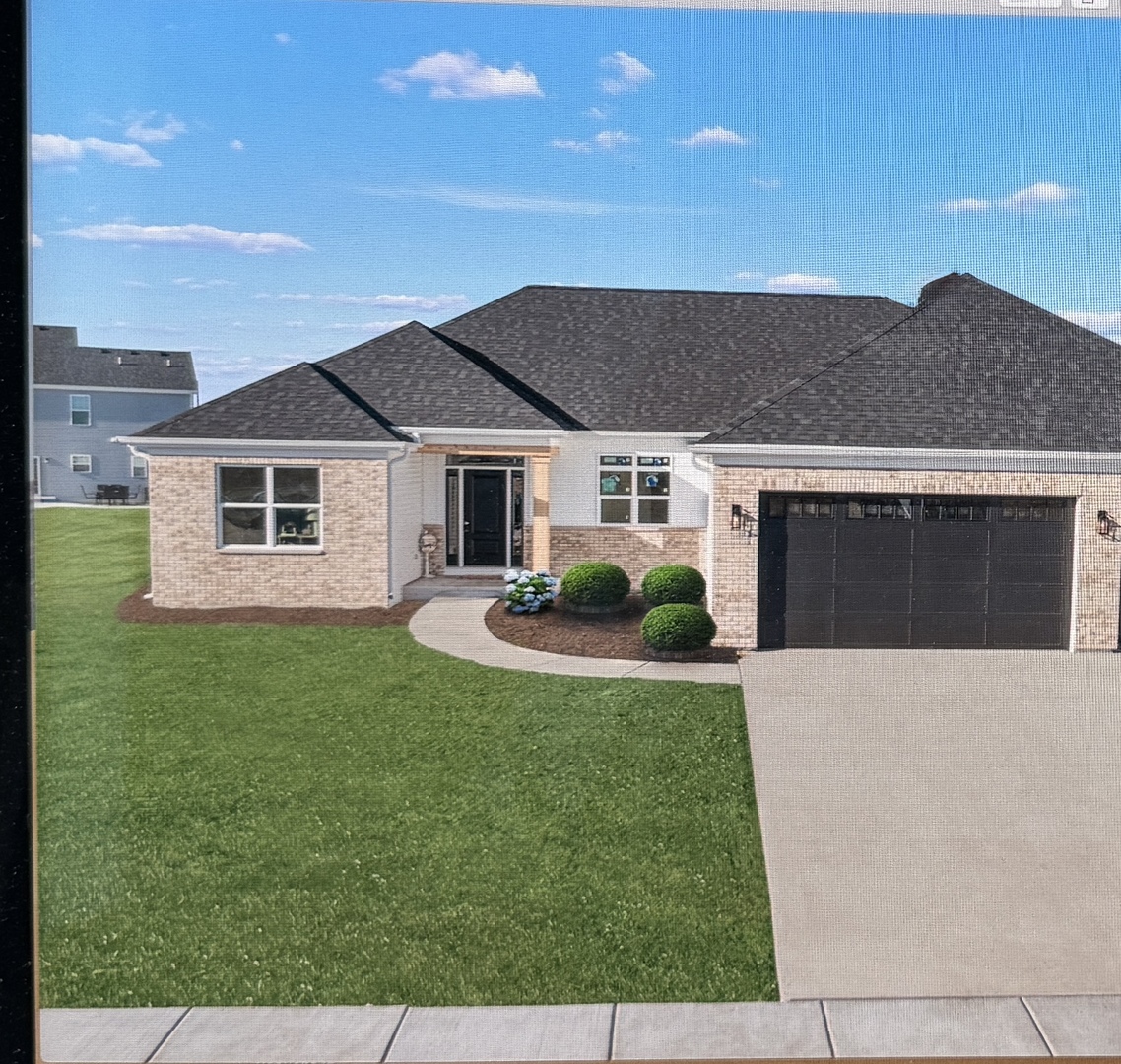 1927 Parkside Drive Sycamore, IL 60178 - Photo 2 of 17 a front view of a house with a yard and garage