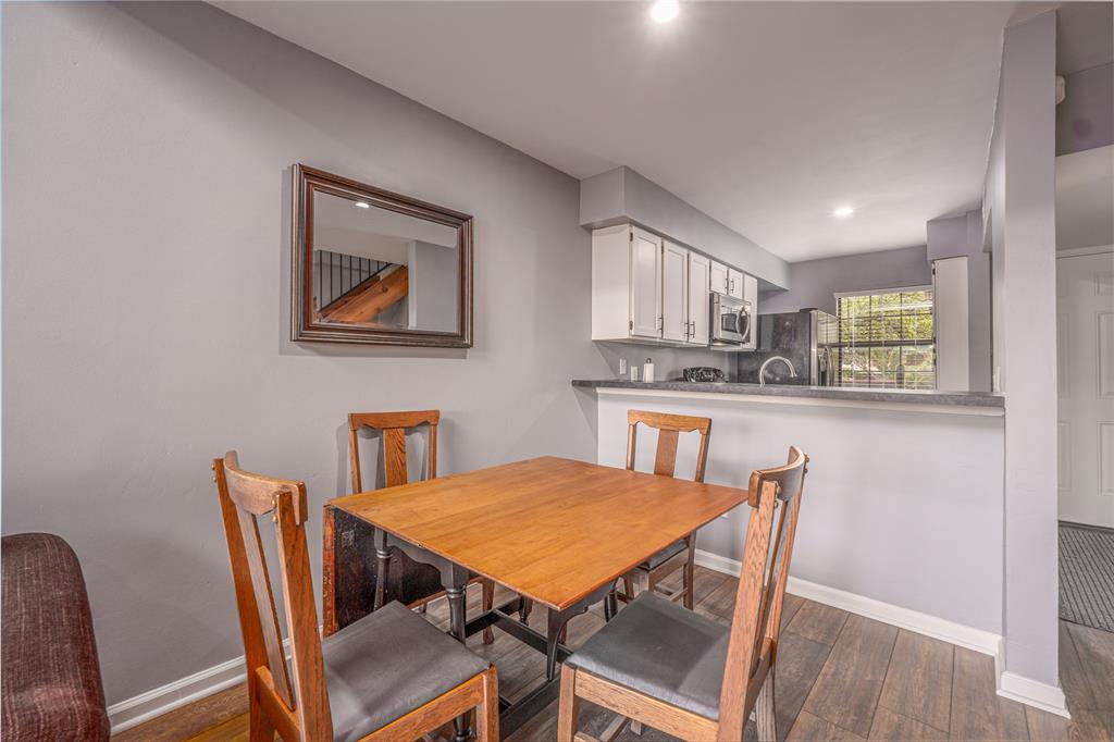 2215 Post Road, Unit 2044 Austin, TX 78704 - Photo 16 of 34 Rich wood-look flooring and recessed lighting define this inviting, open dining space.