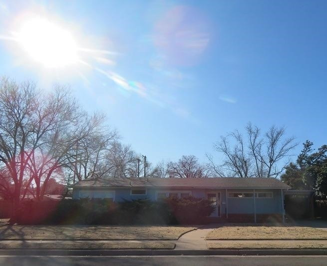 3405 37th Street Lubbock, TX 79413 - Photo 1 of 24 a view of house with trees in the background