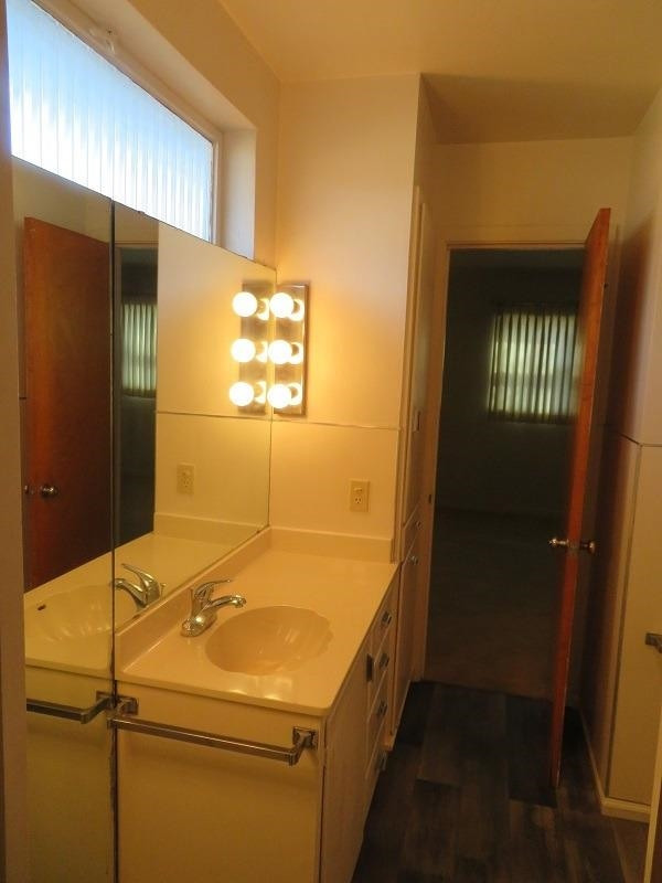 3405 37th Street Lubbock, TX 79413 - Photo 14 of 24 a bathroom with a sink and mirror