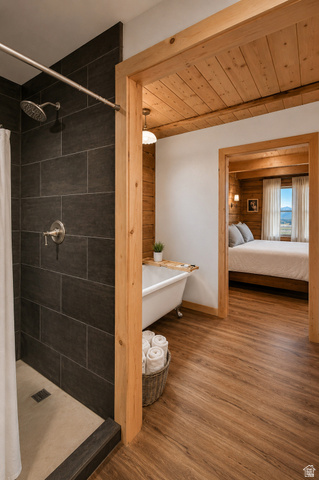 544 East 600 North, Unit 1 Joseph, UT 84739 - Photo 17 of 65 Bathroom featuring a walk-in shower with dark gray tile surround and rainfall showerhead, wood-finish flooring, and a freestanding clawfoot tub