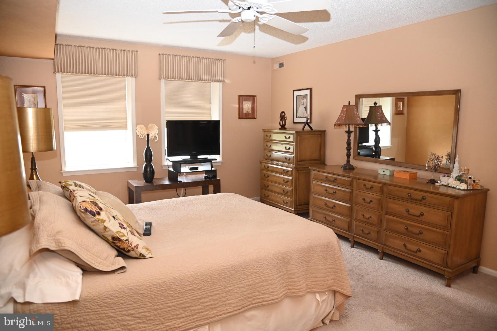 5303 Centennial Station Warminster, PA 18974 - Photo 17 of 60 a bedroom with a bed and a flat tv screen on dresser