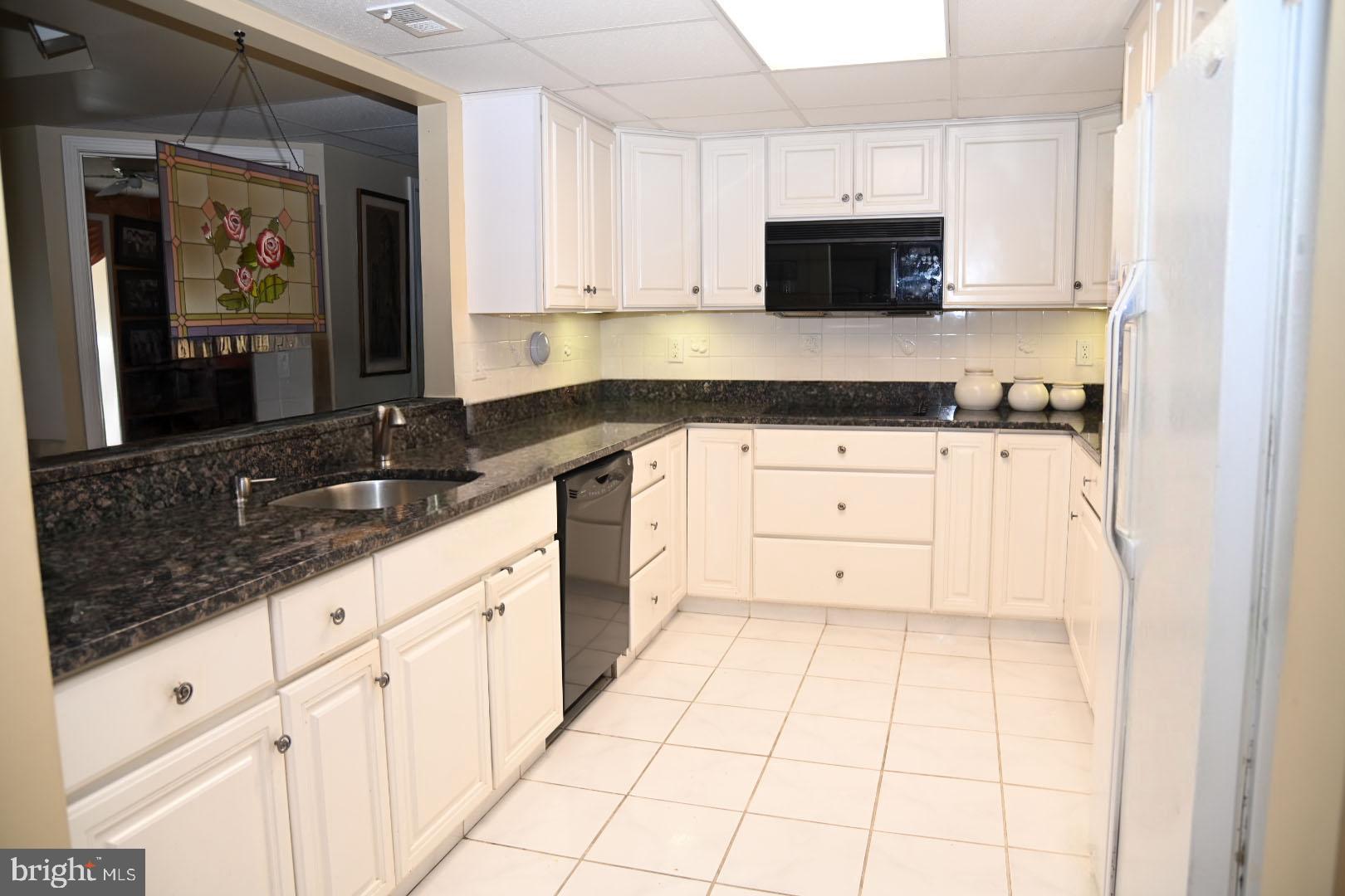 5303 Centennial Station Warminster, PA 18974 - Photo 9 of 60 a kitchen with granite countertop white cabinets and stainless steel appliances