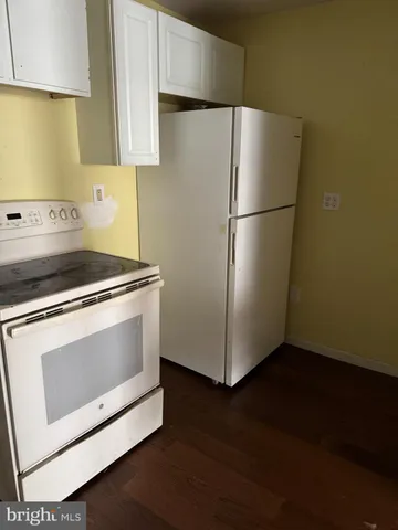a white refrigerator freezer sitting in a kitchen