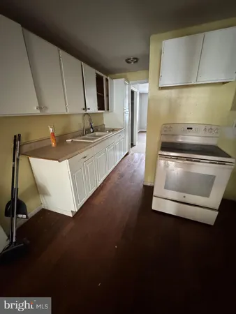 a kitchen with a sink and a stove top oven