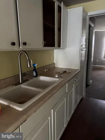 a kitchen with a sink and cabinets
