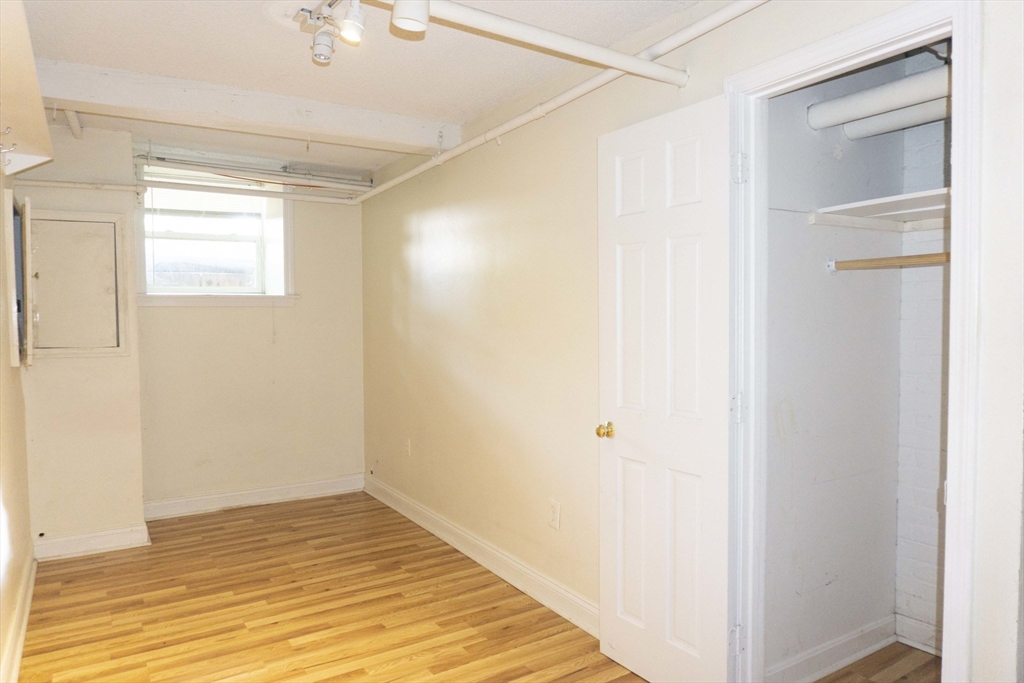 1789 Commonwealth Avenue, Unit 1 Boston, MA 02135 - Photo 4 of 11 a view of an empty room with wooden floor