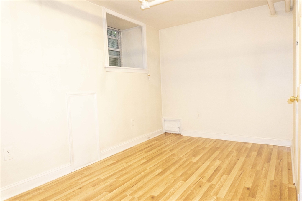 1789 Commonwealth Avenue, Unit 1 Boston, MA 02135 - Photo 8 of 11 a view of empty room with wooden floor