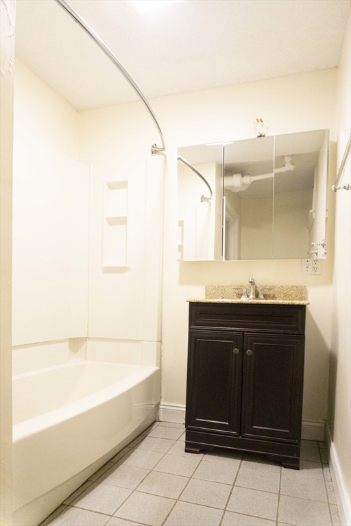 1789 Commonwealth Avenue, Unit 1 Boston, MA 02135 - Photo 10 of 11 a bathroom with a bathtub and a sink