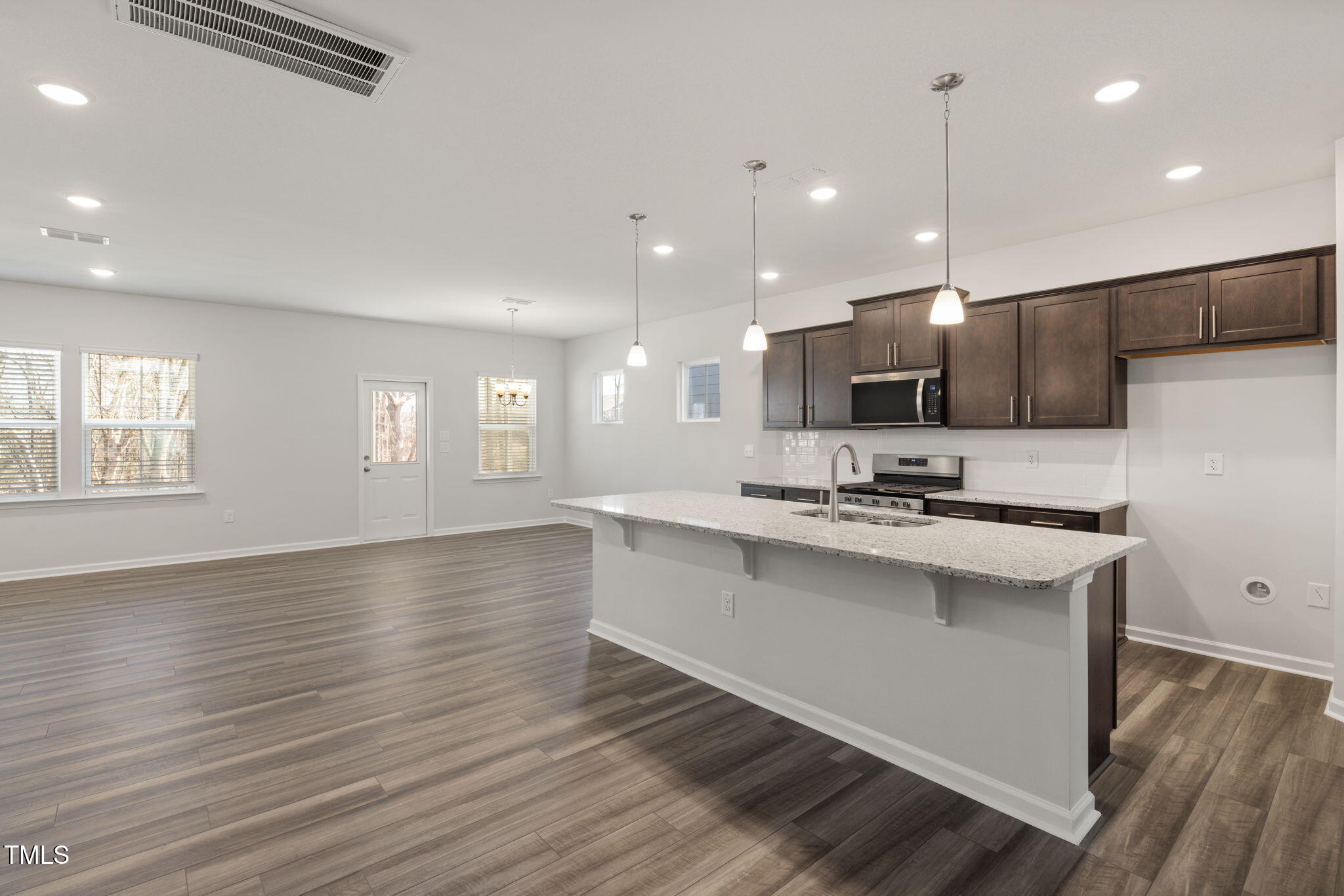 712 Ben Ledi Court Raleigh, NC 27603 - Photo 5 of 21 a kitchen with stainless steel appliances a sink stove and wooden floor