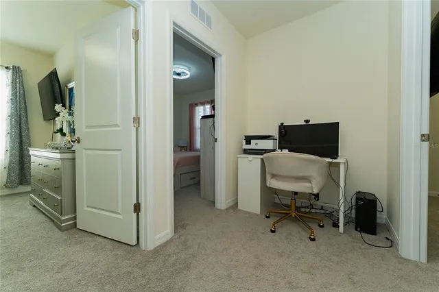 a view of a workspace with furniture and a bathroom