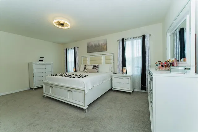 a room with a bed and a dresser