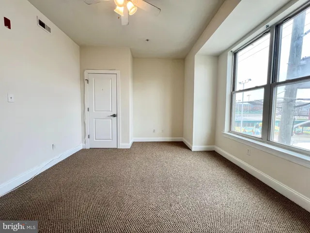 a view of an empty room with a window