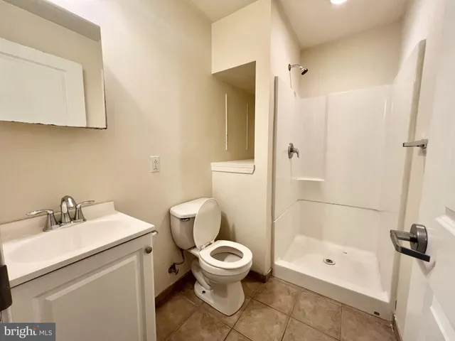 a bathroom with a toilet a sink and shower