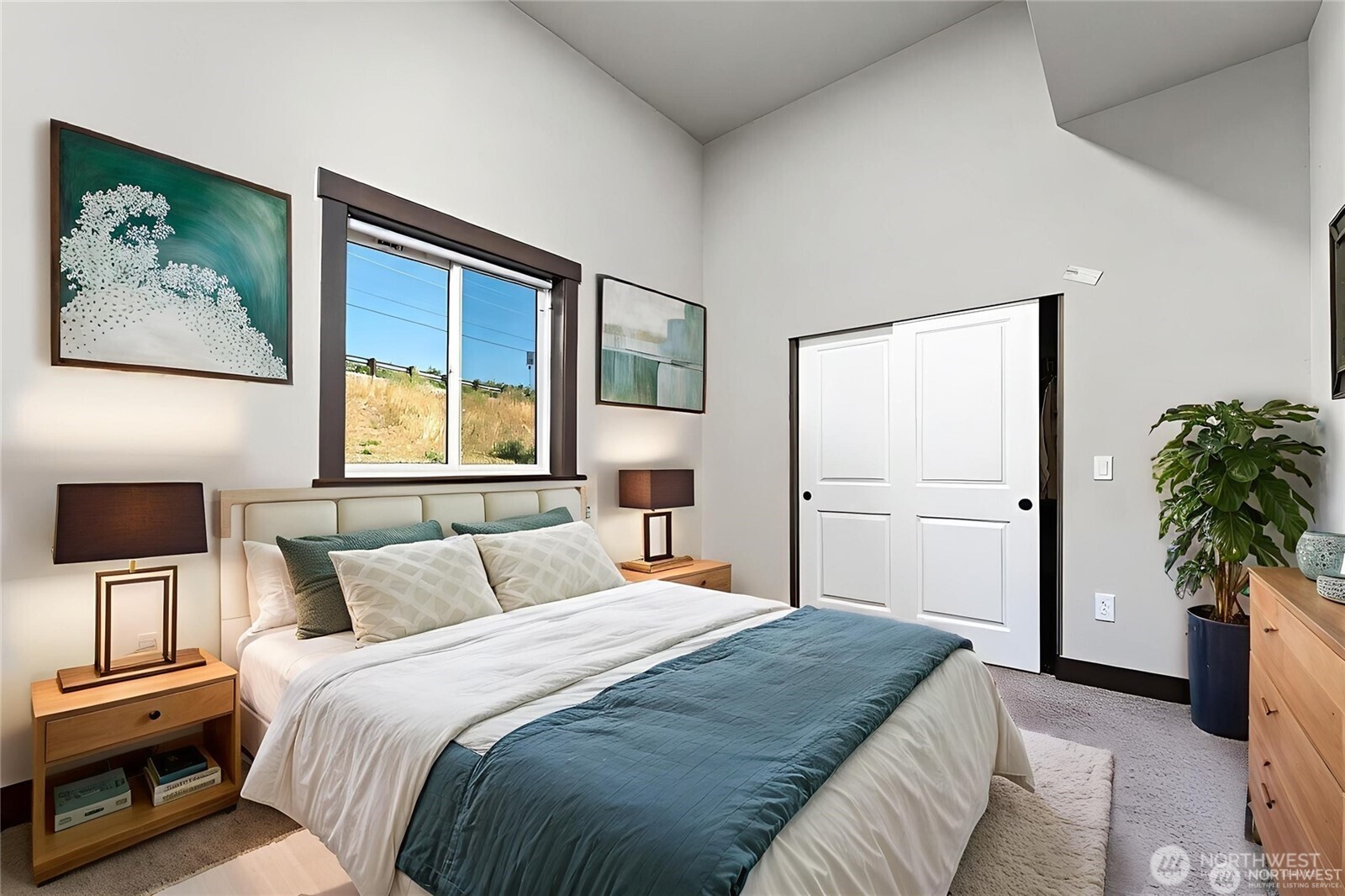 58 Ward Lane Manson, WA 98831 - Photo 21 of 37 a bedroom with a large bed and a painting on the wall