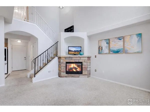 a living room with fireplace and a ceiling fan