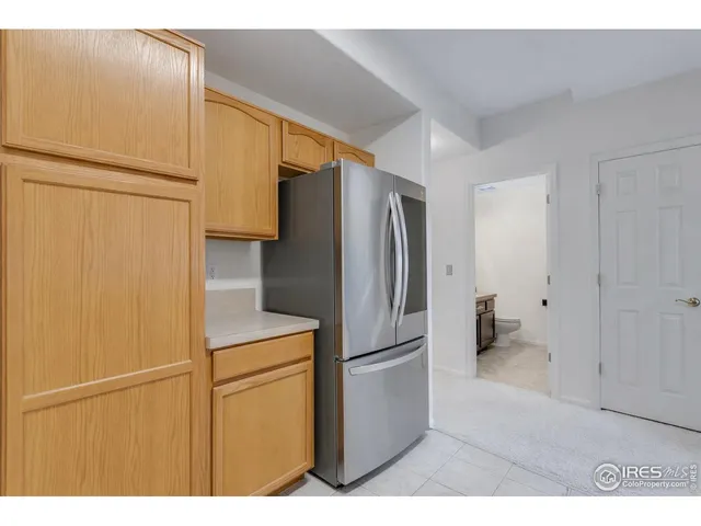 a kitchen with stainless steel appliances a refrigerator and a cabinets