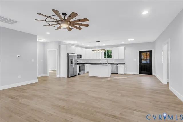 a view of a kitchen with a sink stainless steel appliances