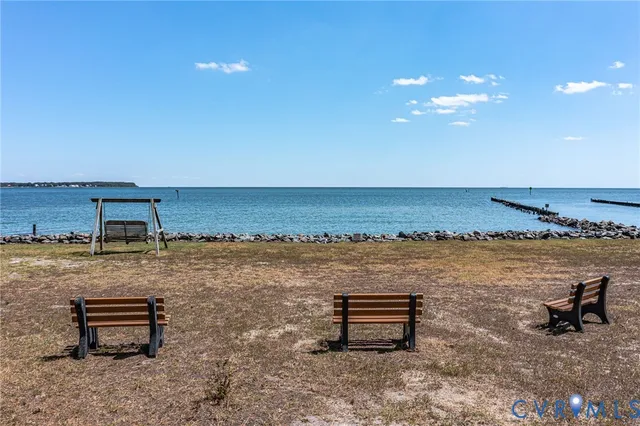 a view of a ocean with chairs