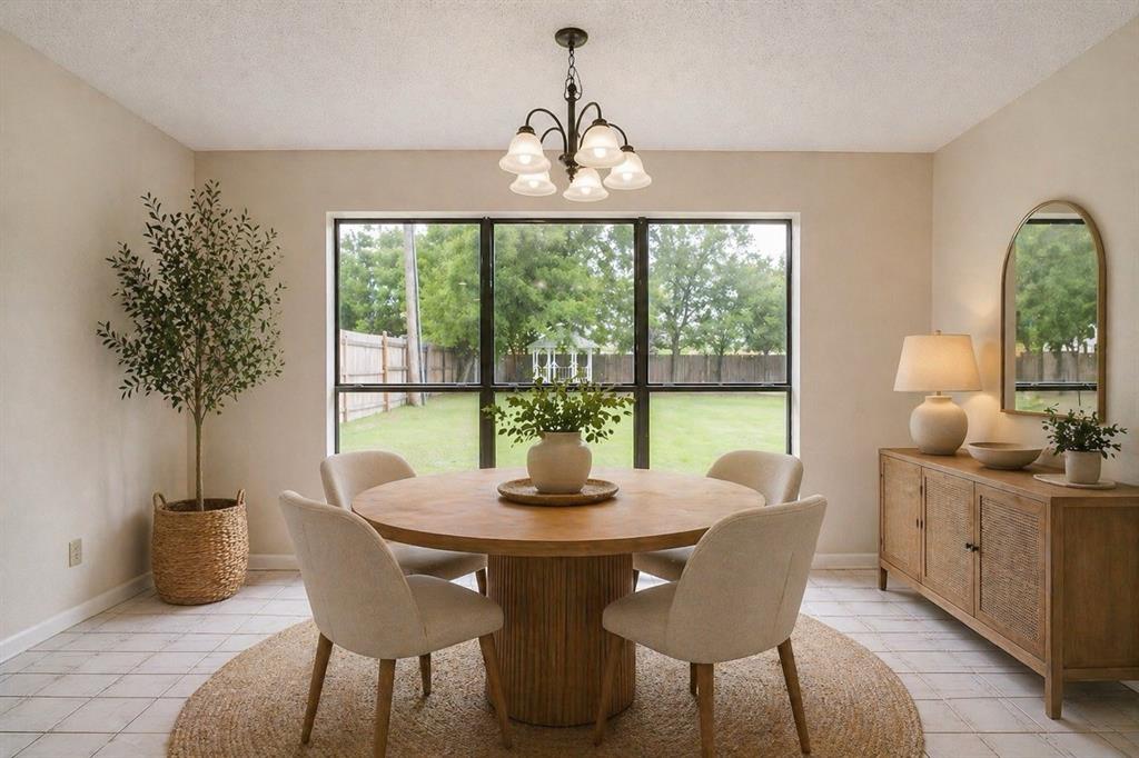 8613 Silver Creek Road White Settlement, TX 76108 - Photo 13 of 40 a dining room with furniture a chandelier and wooden floor