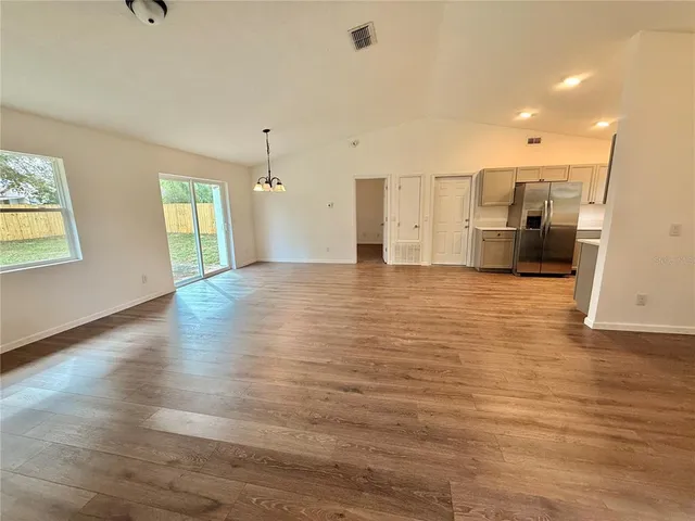 a view of a kitchen with a sink and a large window