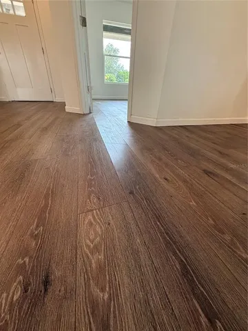 a view of wooden floor and brick walls
