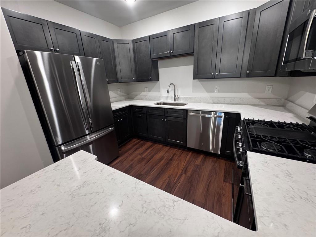 1777 Temple Avenue, Unit O Atlanta, GA 30337 - Photo 4 of 22 a kitchen with wooden floors and wooden cabinets
