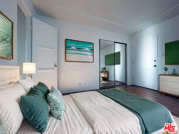a bedroom with a bed and a large window