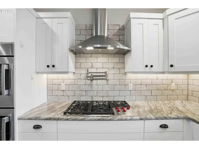 a kitchen with a stove and cabinets