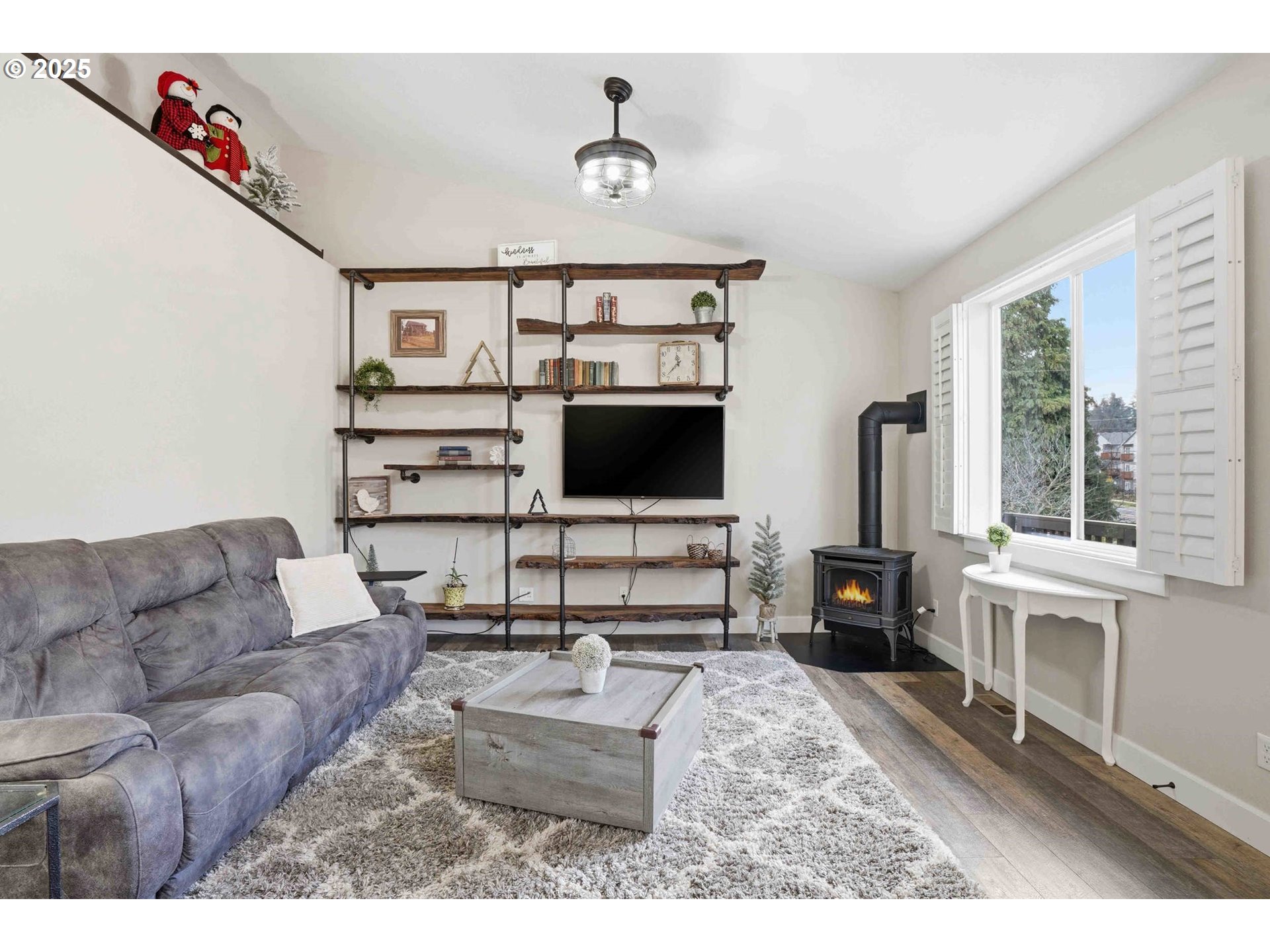 112 Summit View Avenue Southeast Salem, OR 97306 - Photo 18 of 47 a living room with furniture a flat screen tv and a floor to ceiling window