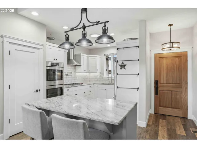 a kitchen with cabinets and wooden floor