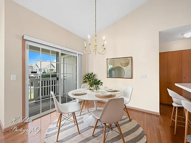 a dining room with furniture a chandelier and wooden floor