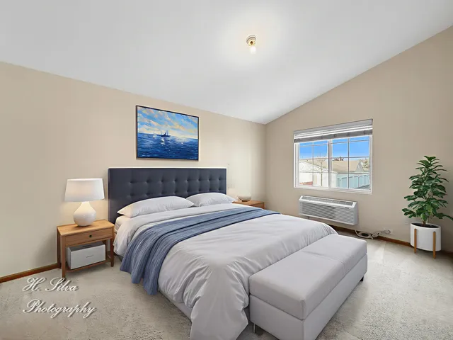 a bedroom with bed and a window