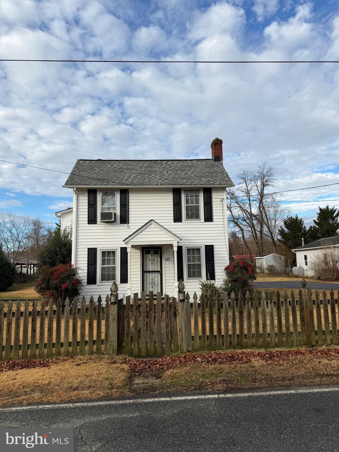7203 Benedict Avenue Benedict, MD 20612 - Photo 1 of 23 a front view of a house with a fence