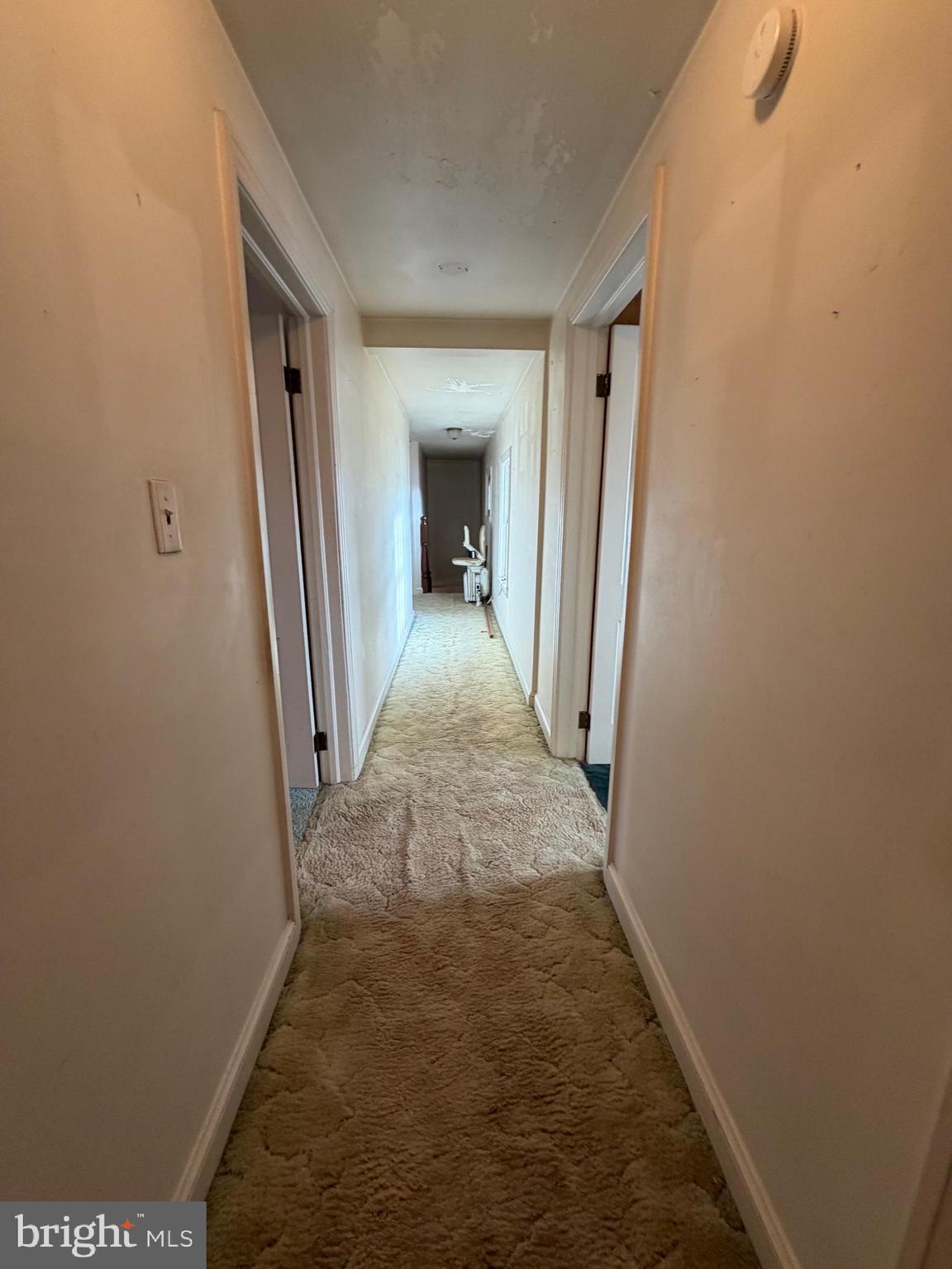 7203 Benedict Avenue Benedict, MD 20612 - Photo 22 of 23 a view of a hallway with wooden floor and a livingroom