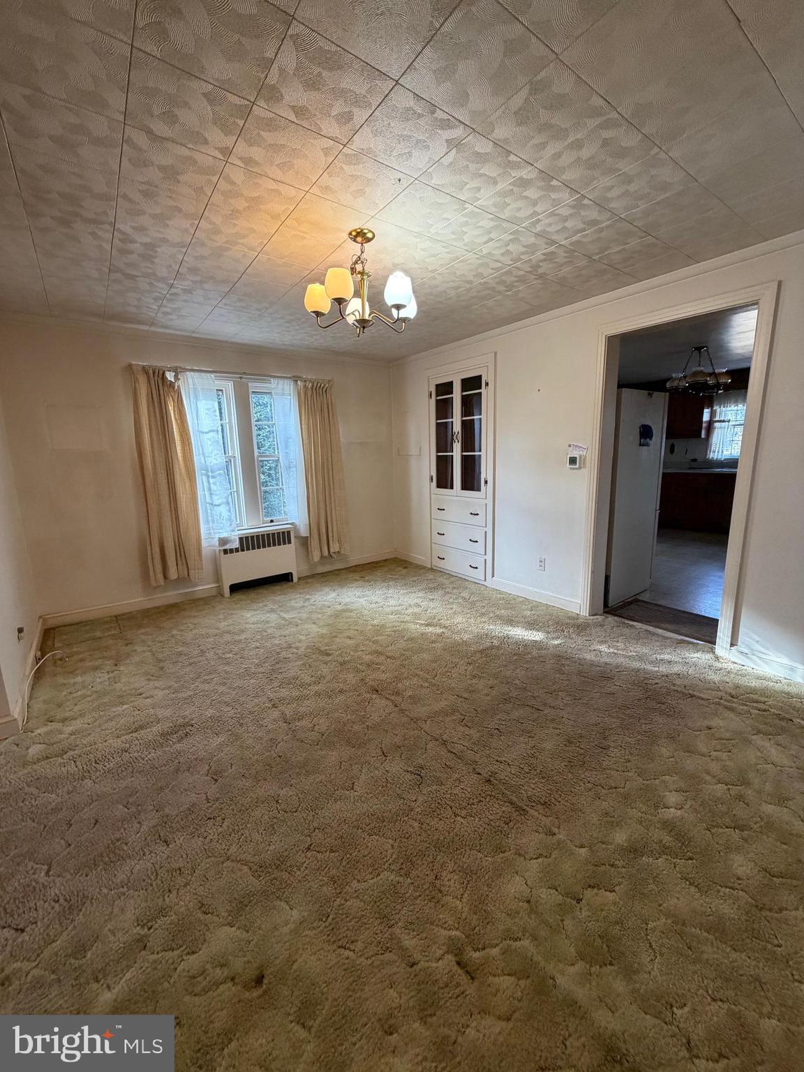 7203 Benedict Avenue Benedict, MD 20612 - Photo 6 of 23 wooden floor in an empty room with a chandelier