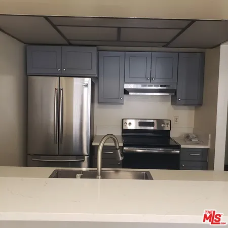 a kitchen with a sink and a refrigerator