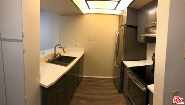a kitchen with a sink and a refrigerator