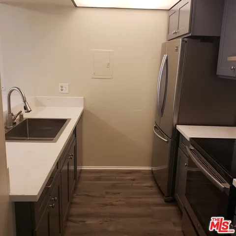 a kitchen with a sink and a refrigerator