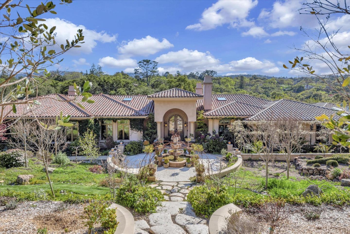28025 Natoma Road Los Altos Hills, CA 94022 - Photo 16 of 44 a front view of a house with a garden