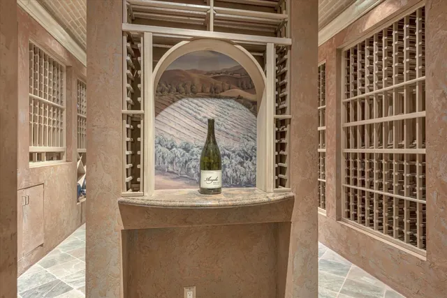 a living room with furniture cabinets and a large window