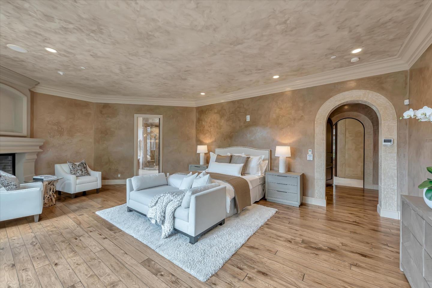 28025 Natoma Road Los Altos Hills, CA 94022 - Photo 33 of 44 a spacious bedroom with a bed and couch