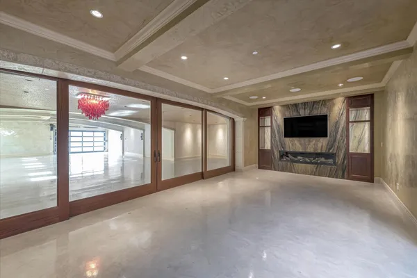 a view of an empty room with a fireplace and a window