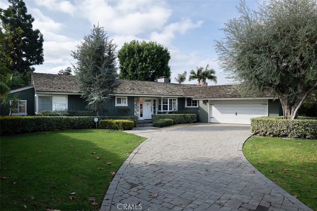 1222 Sharon Road Santa Ana, CA 92706 - Photo 2 of 34 a front view of a house with a garden and yard
