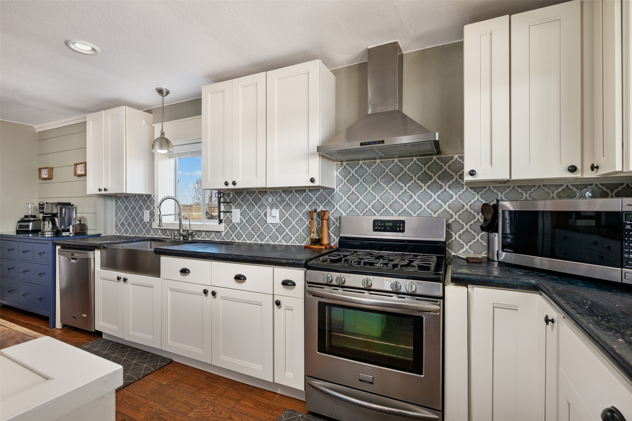 6501 County Road 239 Jarrell, TX 76537 - Photo 8 of 40 Kitchen featuring white cabinetry, wood and concrete counters, stainless steel appliances, and decorative backsplash
