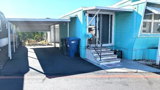 a view of a patio with table and chairs